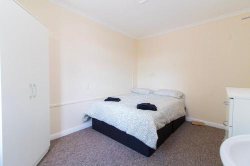 a small bedroom with a bed and a sink at Brookvale Guest House Room 13 in Southampton