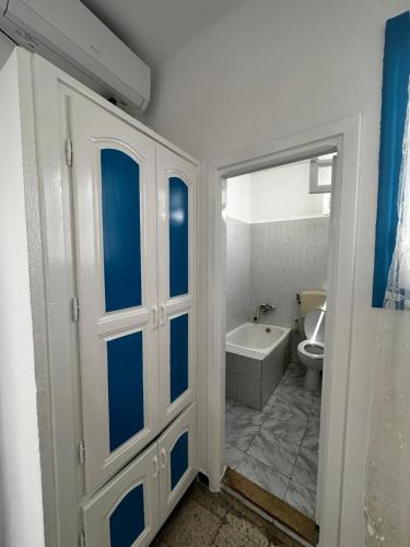 a bathroom with a toilet and a bath tub at Hotel Paris in Sousse