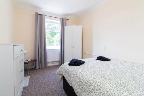a bedroom with a bed and a large window at Brookvale Guest House Room 13 in Southampton