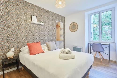 une chambre avec un lit avec deux serviettes dessus dans l'établissement L'Escale - appartement cosy 1 chambre - proche, à Rennes