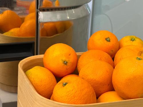 a bunch of oranges in a wooden basket at Boutique Hotel Sirmione in Sirmione