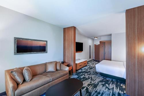 a hotel room with a couch and a bed at Fairfield Inn & Suites by Marriott Liberal in Liberal