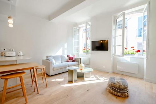 un salon blanc avec un canapé et une table dans l'établissement Petit Gambetta l Bright & Fresh l Shellter Rentals, à Saint-Tropez