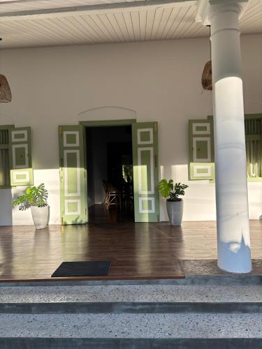a lobby with potted plants in a building at Chathra Rajgama in Rathgama
