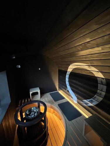 a wooden boat with a chair in a room at kumihimo kobe in Wada
