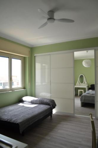 a bedroom with a bed and a ceiling fan at Fondachello Suites - tra il vulcano e il Mar Ionio in Mascali