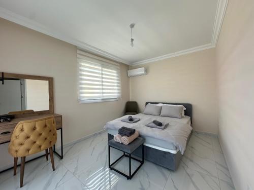 a bedroom with a bed and a desk and a mirror at Villa Royal Sun Elite 29 by MyGuest Cyprus in Iskele