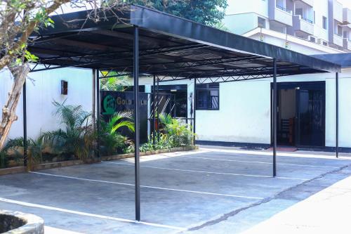 a parking lot in front of a building at Gold Palm Hotel in Gulu