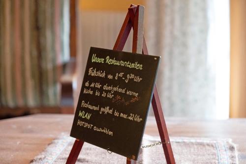 a chalkboard sign sitting on top of a table at Gasthaus Heiligenbrunnen in Titisee-Neustadt