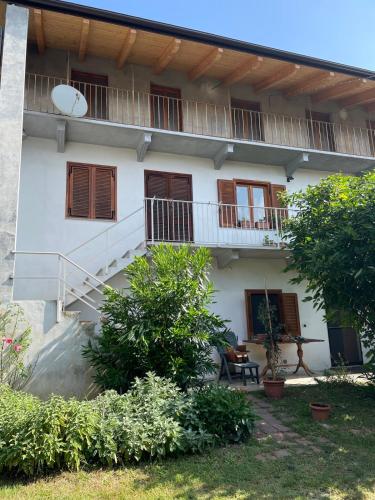 a white building with a staircase in front of it at Appartamento Via Piane Azeglio in Azeglio