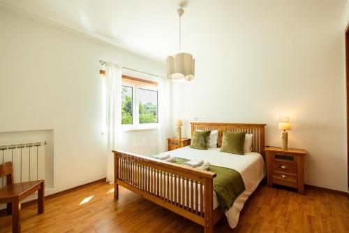 a bedroom with a bed and a window at Blue Beach by ACasaDasCasas in Ericeira