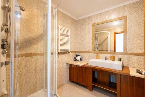 a bathroom with a sink and a shower at Blue Beach by ACasaDasCasas in Ericeira