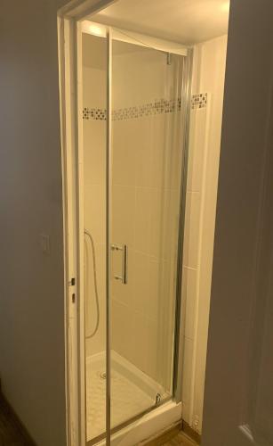 a shower with a glass door in a bathroom at Clalou in Sérignan