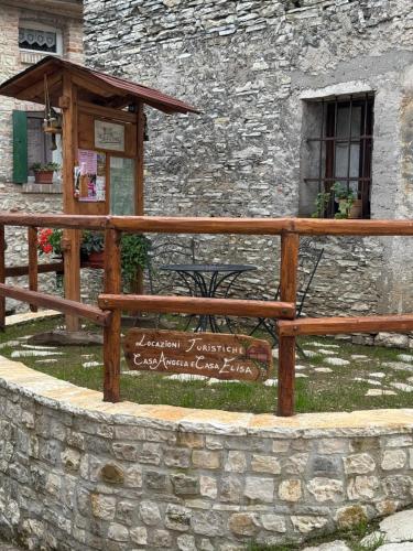 a wooden bench in front of a stone building at CASA NONNA ELISA Stayerat a SEGUSINO Valdobbiadene in Segusino