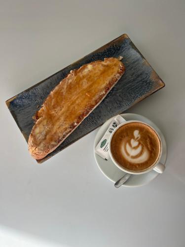 a plate with a pastry and a cup of coffee at Espacio San Juan de la Cruz in Fontiveros