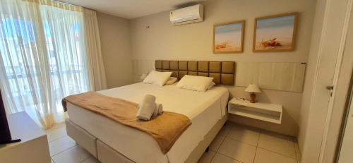 a small bedroom with a bed and a window at Atlantic Palace Family inn in Aquiraz