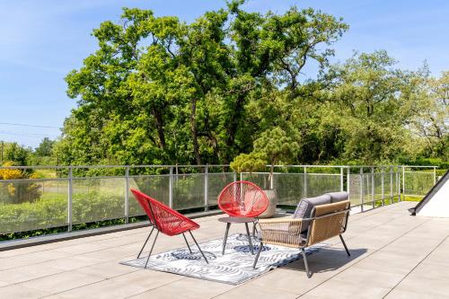 three chairs and a table on a patio at Kerwall - Maison d'hôtes in Malville