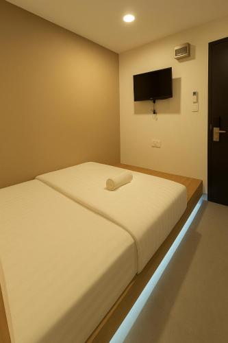 a bedroom with two beds and a flat screen tv at D'Garden Hotel Kuala Lumpur in Kuala Lumpur