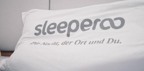 a white pillow with the word sleeperved on it at Schönster Seeblick am Mondsee - Cubes - SELF CHECK-IN in Mondsee