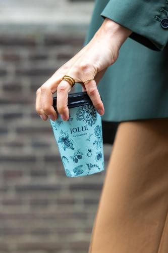 a woman is holding a bag in her hand at Townhouse Den Haag in The Hague