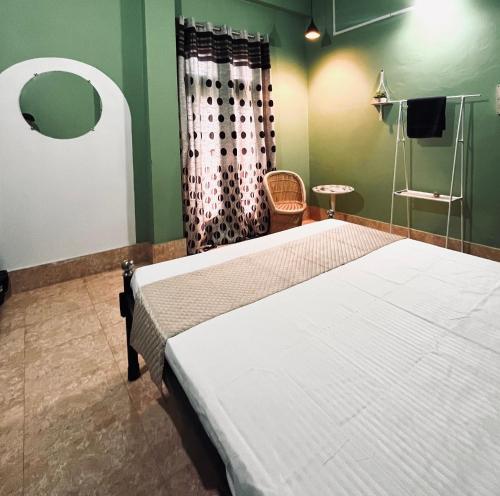a bedroom with a bed and a shower at Townsville in Jorhāt