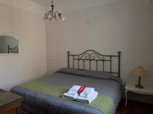a bedroom with a bed with towels and a mirror at Hotel Lyon by MH in Buenos Aires