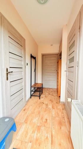 a hallway with two doors and a wooden floor at Pokój Słoneczna Idylla k Karpacza SAUNA JACUZZI in Podgórzyn