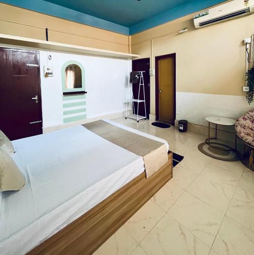 a bedroom with a large bed and a table at Townsville in Jorhāt
