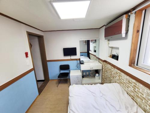 a room with a bed and a desk and a computer at Sweet House in Seoul