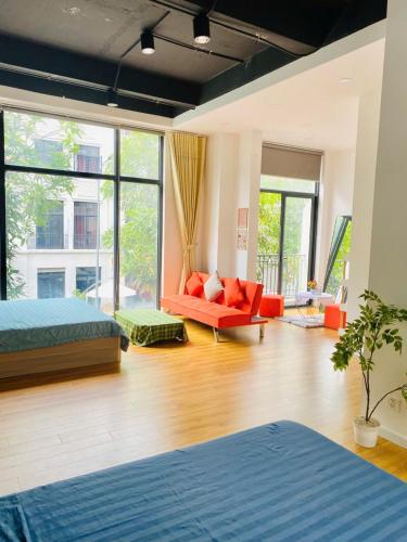 a room with two beds and a couch in it at Happy House in Ho Chi Minh City