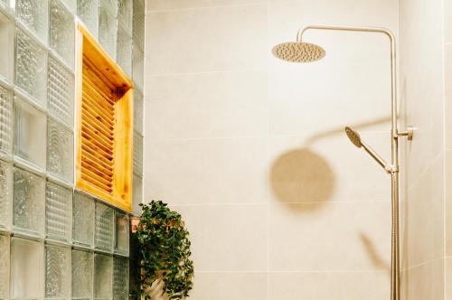 a shower in a bathroom with a window at Happy House in Ho Chi Minh City