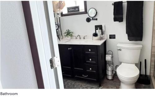 ein Badezimmer mit weißer Toilette und Waschbecken in der Unterkunft BEST Riverfront Parker Home in Parker