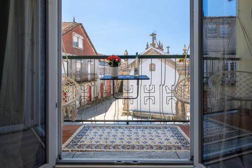 an open door with a view of a balcony at Casa Pinheiro in Pinheiro de Coja