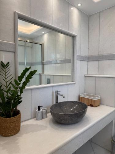 a bathroom with a stone sink and a mirror at Anemoessa in Naxos Chora