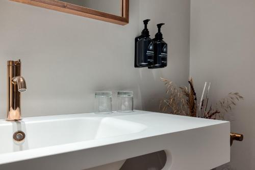 a white sink with two glasses on top of it at Hotel Indigo Gandia Beach by IHG in Gandía