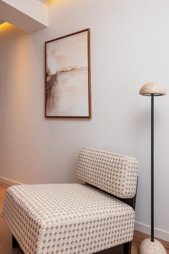 a living room with a chair and a picture at Hotel Indigo Gandia Beach by IHG in Gandía