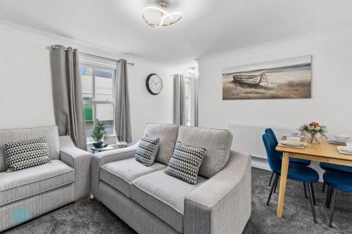 a living room with a couch and a table at The Barracks by Pureserviced in Plymouth