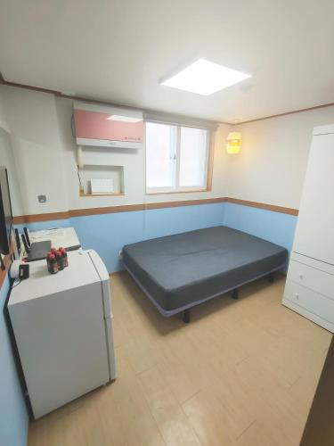 a hospital room with a bed and a refrigerator at Sweet House in Seoul