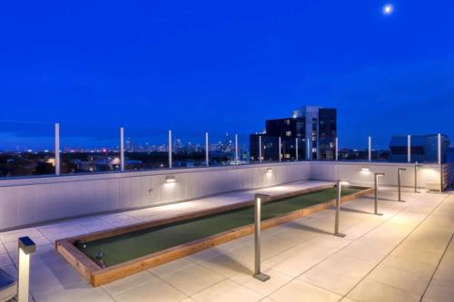 a swimming pool on the roof of a building at night at 1BR City Loft With Modern Glass Views in Chicago