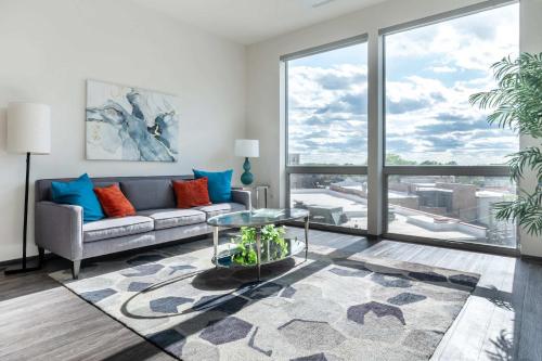 a living room with a couch and a glass table at 1BR City Loft With Modern Glass Views in Chicago