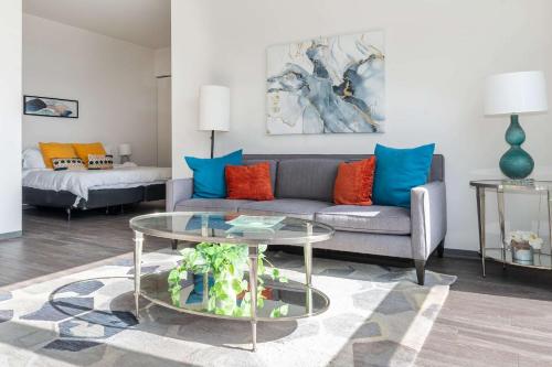 a living room with a couch and a glass table at 1BR City Loft With Modern Glass Views in Chicago