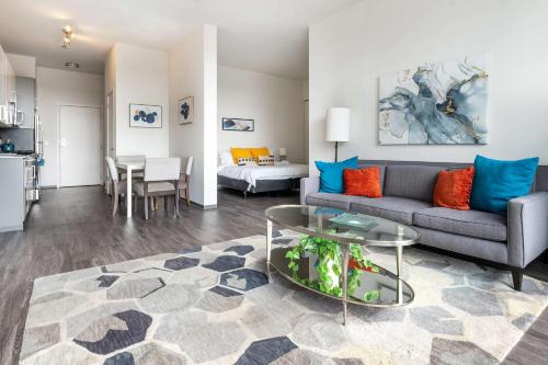 a living room with a couch and a table at 1BR City Loft With Modern Glass Views in Chicago