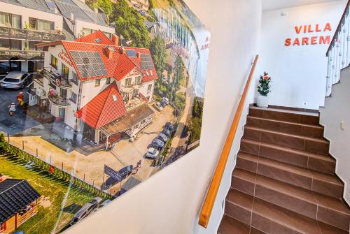 a mural of a house on the wall in a hallway at Villa Sarema in Chłopy