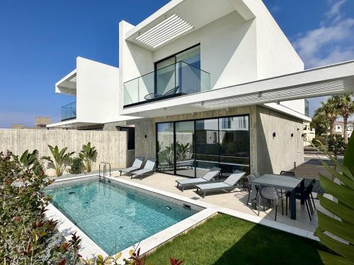 an image of a house with a swimming pool at Elysian Blue villa 3 in Paphos City