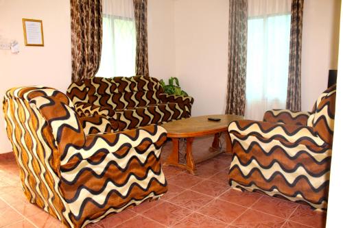 a living room with two couches and a table at Harmony house apartments in Ker Bakary