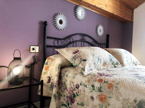 a bedroom with a bed and two mirrors on the wall at Casa da Miniña in Quilmas