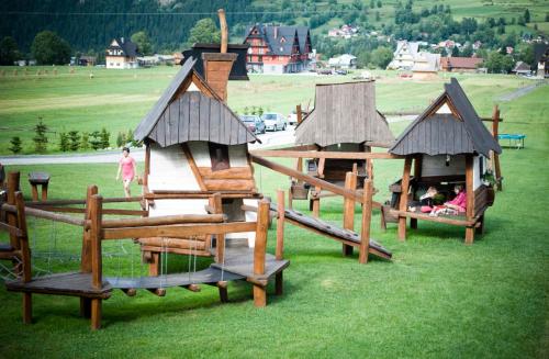 a group of play structures in a field at Hotel ZAWRAT Ski Resort & Spa in Białka Tatrzanska