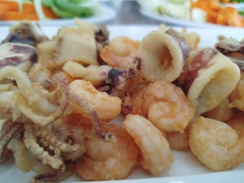 a plate of food with shrimp on a table at Stella Maris Hotel in Ginosa Marina