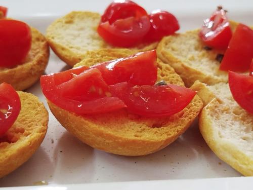 a group of small sandwiches with tomatoes on them at Stella Maris Hotel in Ginosa Marina