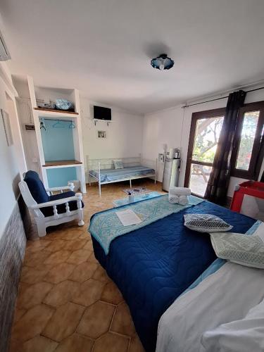 a bedroom with a large blue bed in a room at Agriturismo Pira Pinta in Dorgali